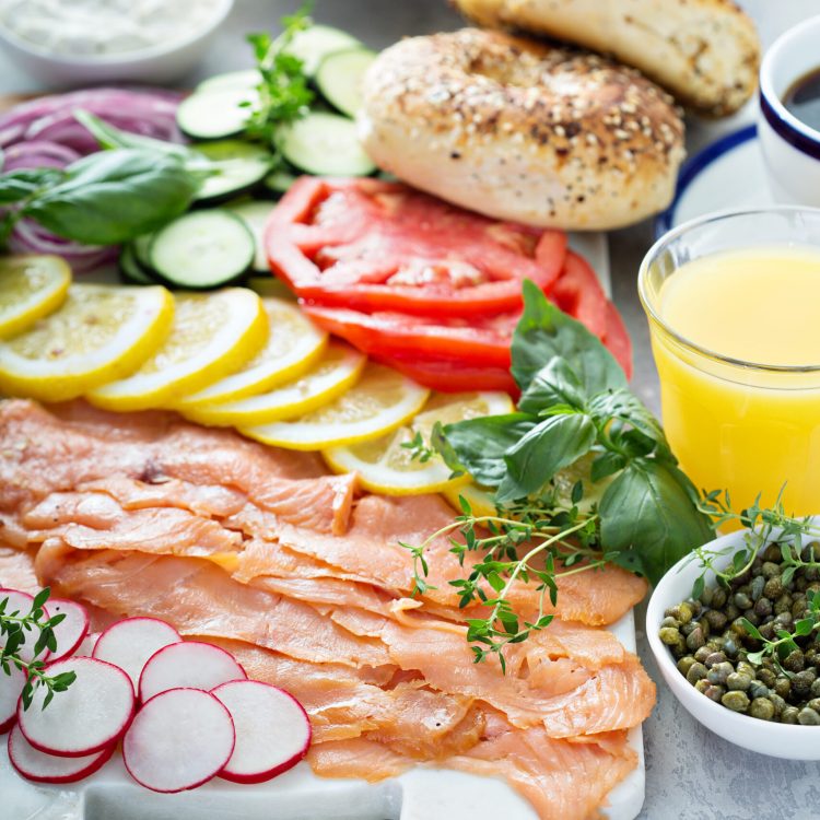 Bagels and lox platter for breakfast with vegetables and cream cheese